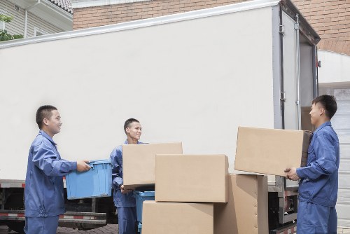 Professional movers loading furniture for a small removal in Kew