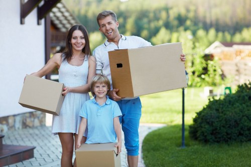 Professional movers carrying furniture in Kew